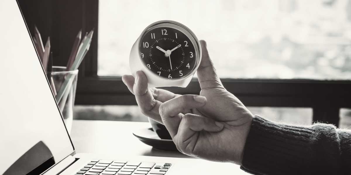 Photo of person holding a clock